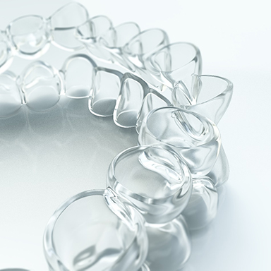 two Invisalign trays sitting on one another 