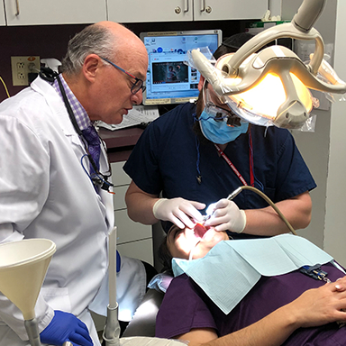 Dr. Mohr and one of his students treating patient
