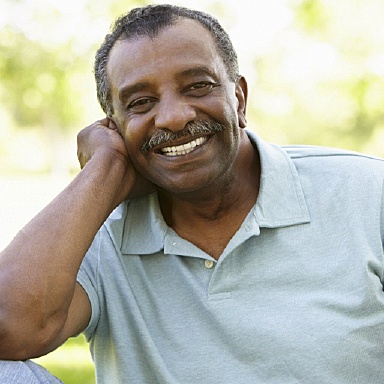 Smiling man with All-on-4 dental implant dentures from Long Island implant dentist, Dr. Allan Mohr