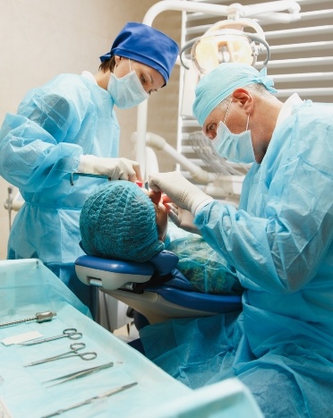 Dentists with masks treating a patient