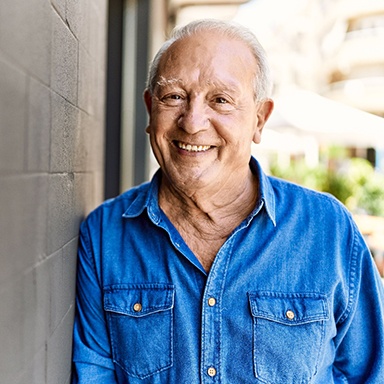 smiling older man with blue shirt 