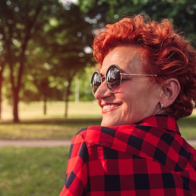 older woman smiling with sunglasses 