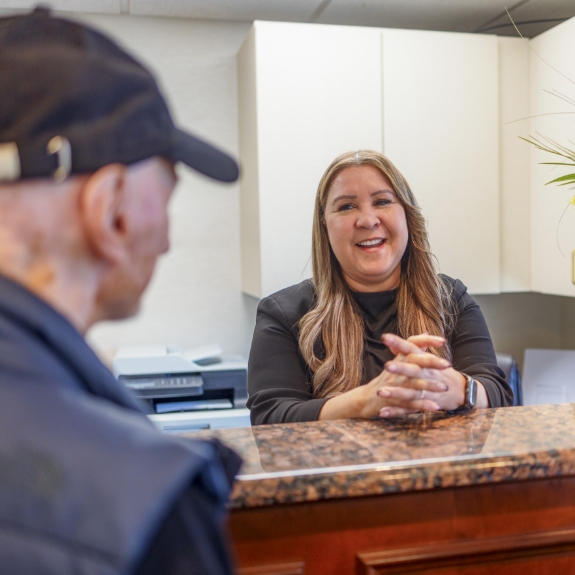 Man checking in at dental office front desk