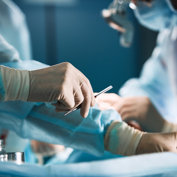 Dental team performing dental implant surgery on a patient
