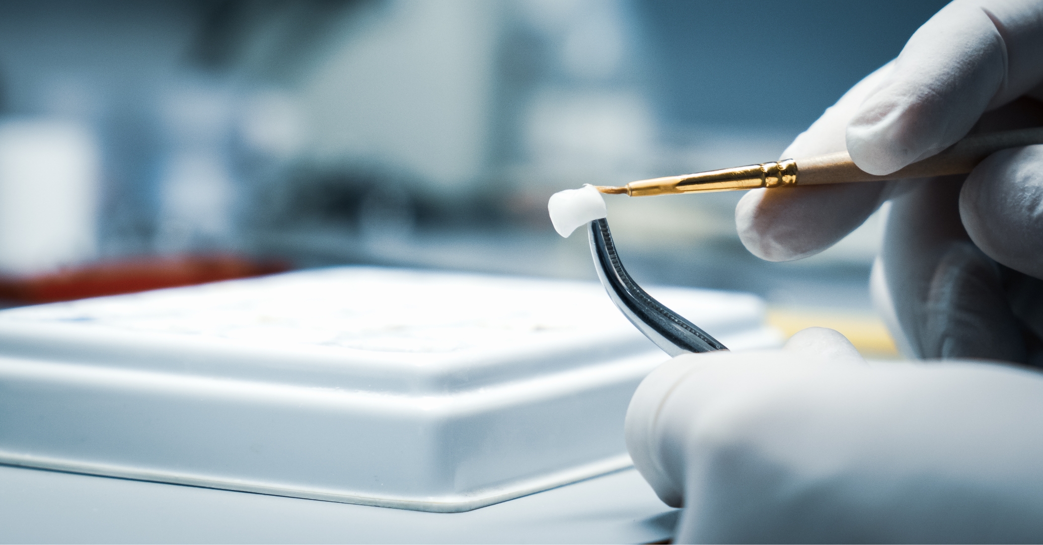 Dental lab technician adjusting a dental crown