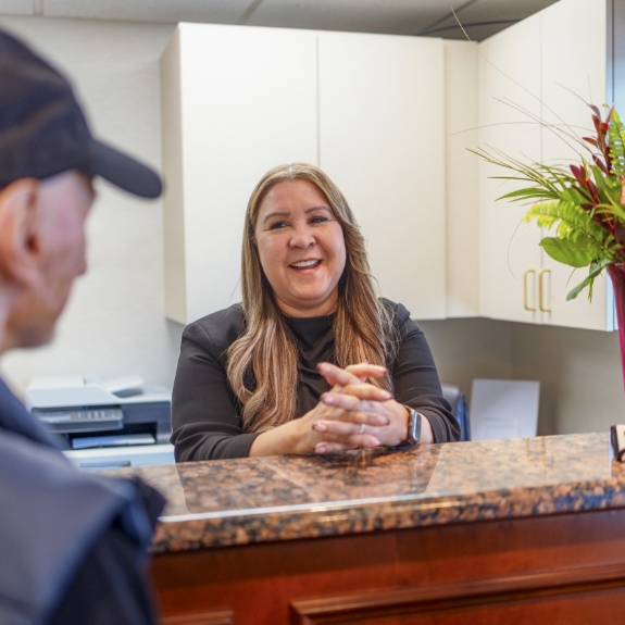 Man checking in at dental office front desk