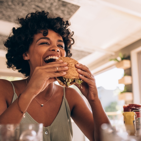 Woman biting into a burger