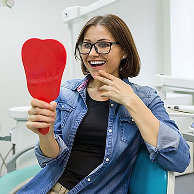 A dental patient wondering who the best Long Island Dental Implant Dentist is