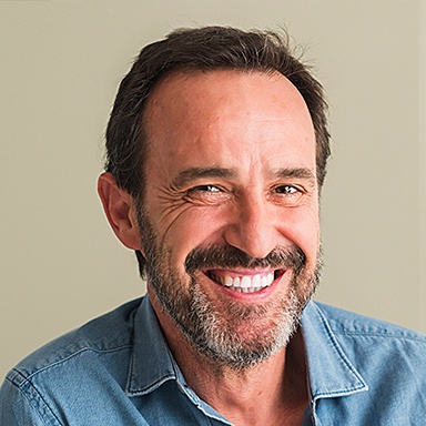 Smiling man with best Long Island dental implants from Dr. Allan Mohr