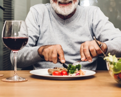 Man cutting vegetables on his plate