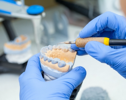 Dental lab tech designing a denture