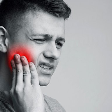 a person suffering from tooth pain