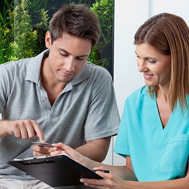 a person paying their dental bill