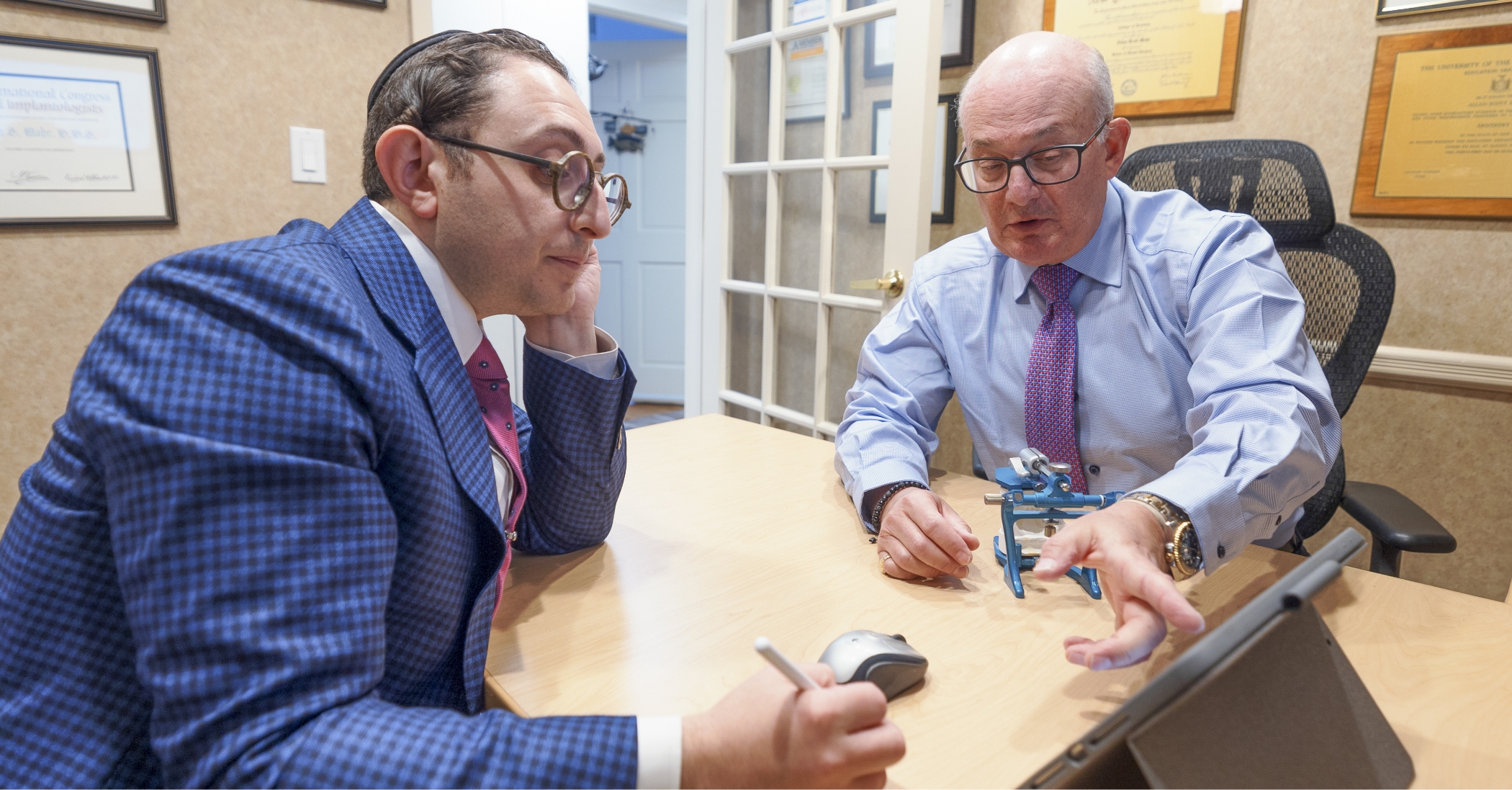 Two Long Island cosmetic dentists having a discussion at a table