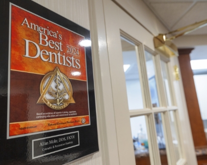 Framed America's Best Dentist 2024 award for Doctor Allan Mohr on the wall of Smile Creations