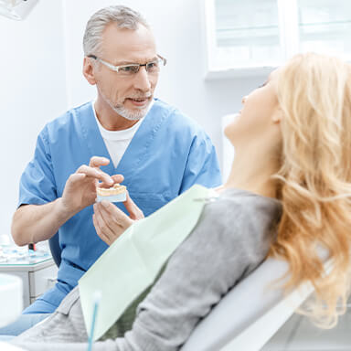 A dental patient wondering who the best Long Island Dental Implant Dentist is