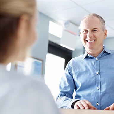 Long island dental patient asking a question about dental implants