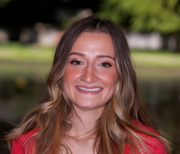 Woman in a red blouse smiling with flawless teeth