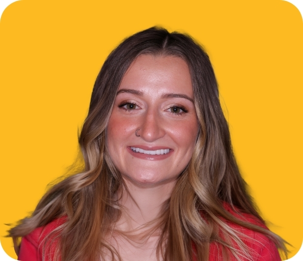 Woman in a red blouse smiling with flawless teeth