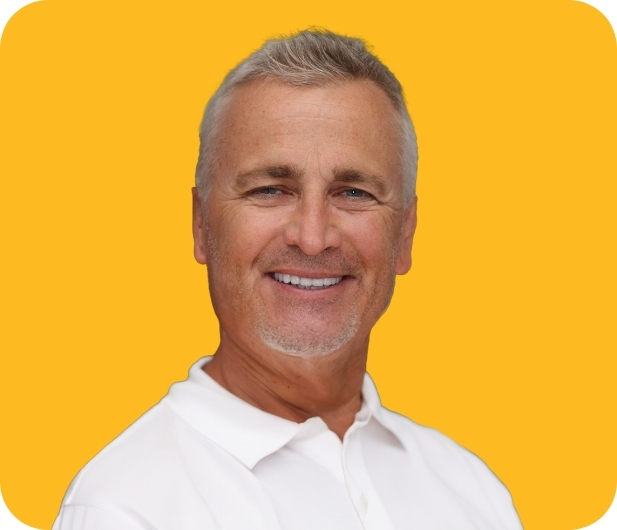 Man in a white collared shirt smiling with white teeth