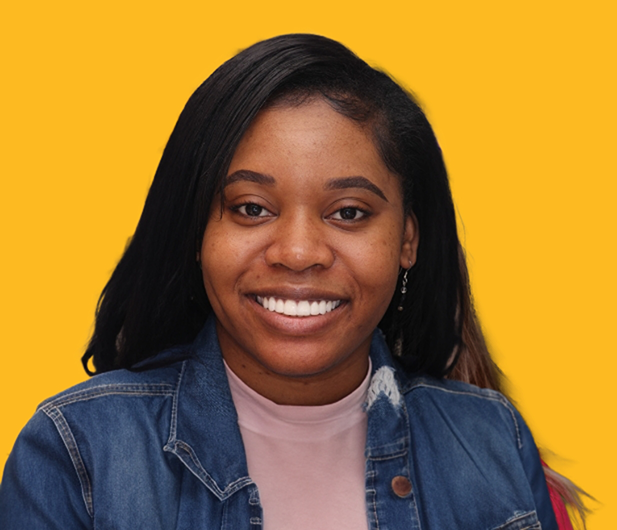 Woman in a denim jacket smiling with bright white teeth