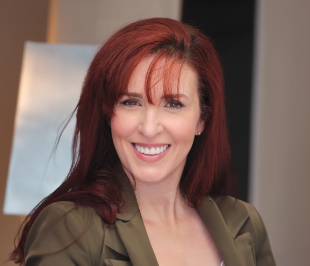 Woman with long red hair smiling with flawless white teeth