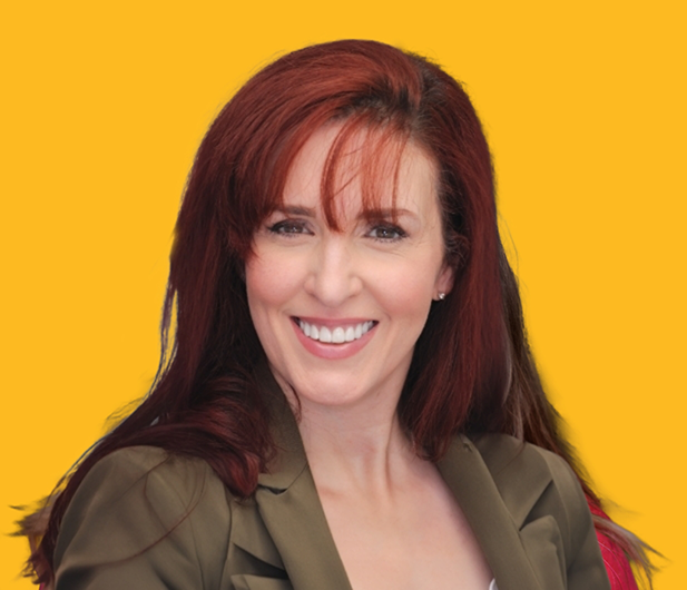Woman with long red hair smiling with flawless white teeth