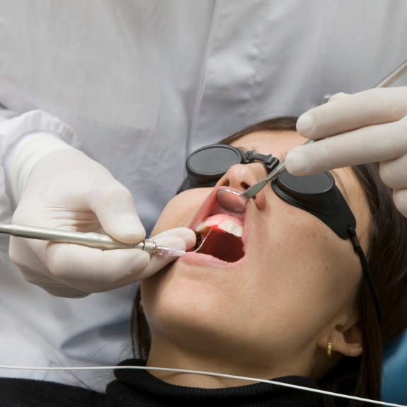 Dental patient having her gums treated with a soft tissue laser