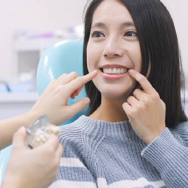 Dr. Mohr checking a dental patient for oral cancer