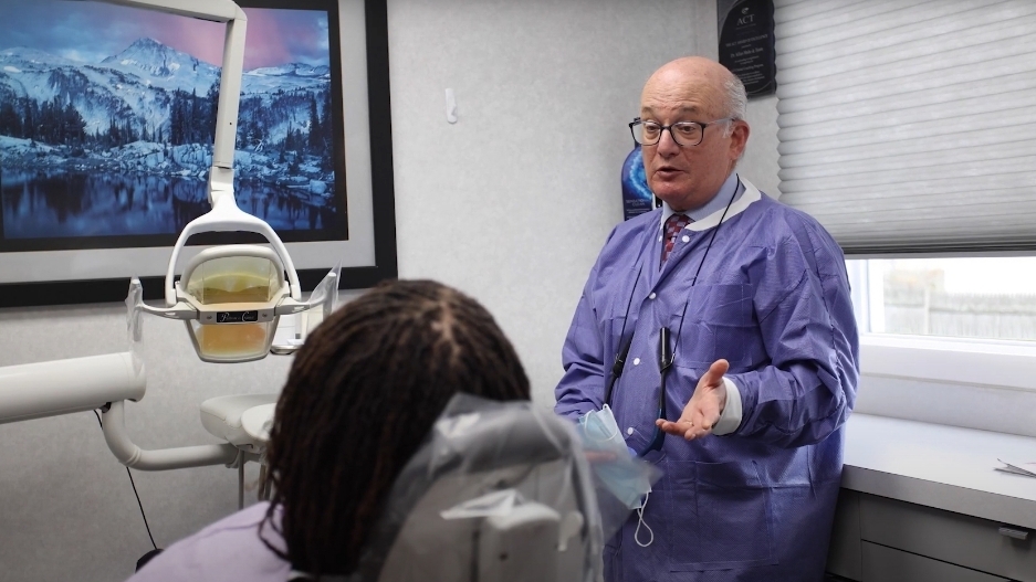 Doctor Mohr explaining something to a woman in the dental chair