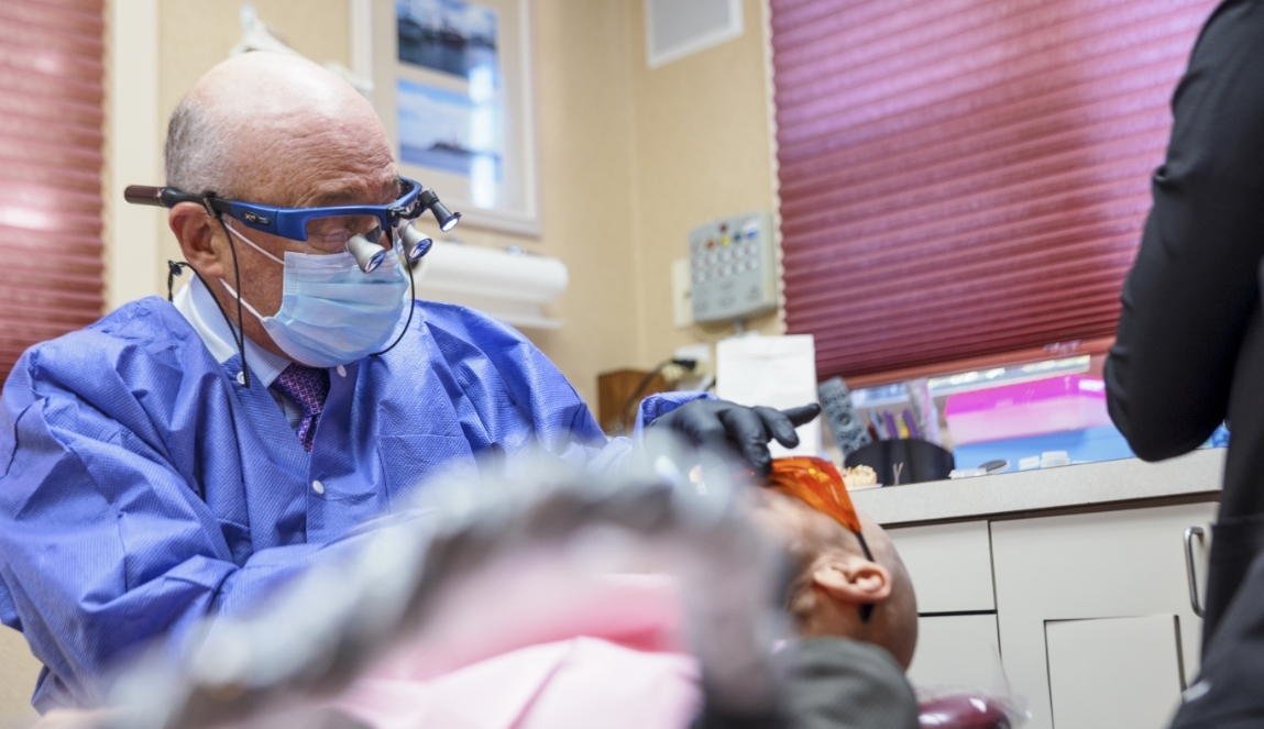 Doctor Mohr wearing dental binoculars while treating a patient