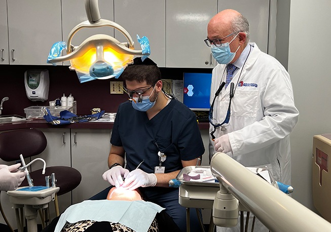 Dr. Mohr and team member with patient performing important dental work