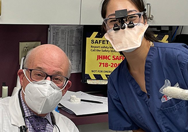 Close-up of Dr. Mohr and dental team member while wearing masks