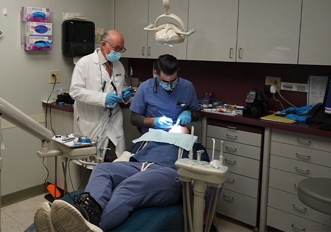 Far shot of Dr. Mohr and team member performing dental treatment