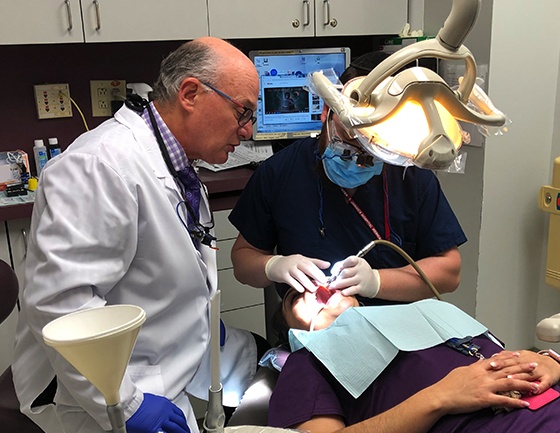 Dr. Mohr teaching a dental student how to place porcelain veneers