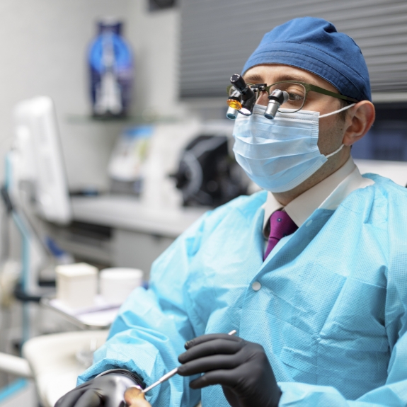 Dentist performing oral cancer screening