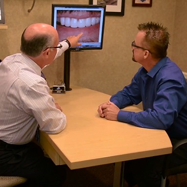 Dentist showing patient smile images