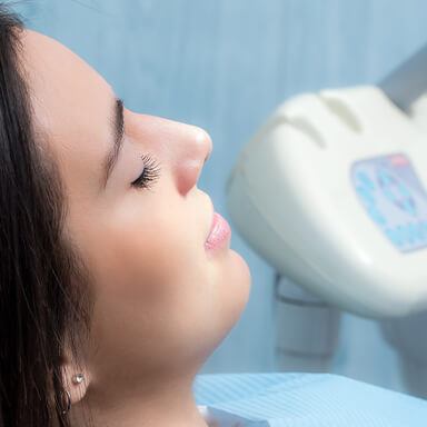 Smiling Long Island dental patient in a dental chair