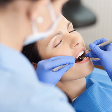 Happy Massapequa Park dental patient in a dental chair