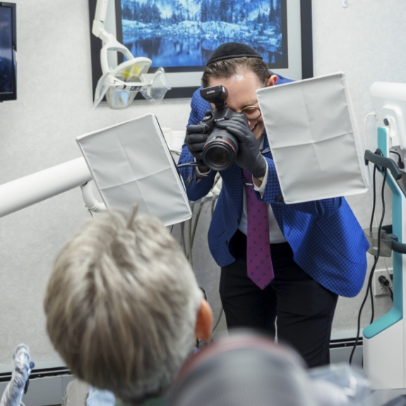 Doctor Ariel taking a photo of a patients teeth