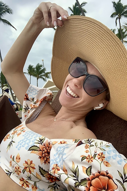 Headshot of Stephanie with a big straw hat and a brighter smile