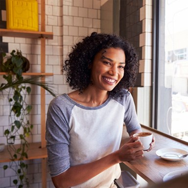 young woman drinking coffee with a friend 