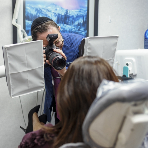 Doctor Ariel taking a photo of a patients teeth