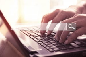 searching online with laptop