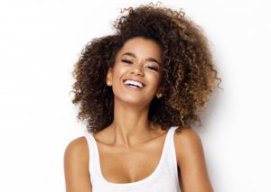 woman in white shirt with perfect smile