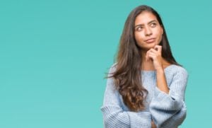 young woman thinking about cosmetic bonding and veneers 