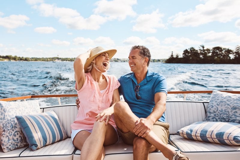 couple sitting on a couch next to ocean