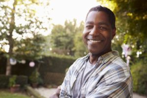 middle-aged man smiling outside