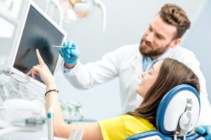 dentist talking to patient about cosmetic dentistry 