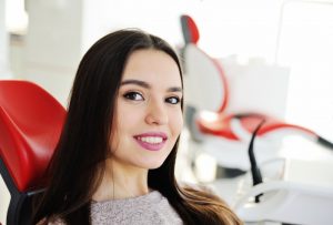 woman with dazzling smile thanks to a Long Island cosmetic dentist 